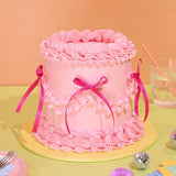 Vintage Cake - Single Colour by Crumbs & Doilies with pink Swiss Meringue icing and ribbon decoration.